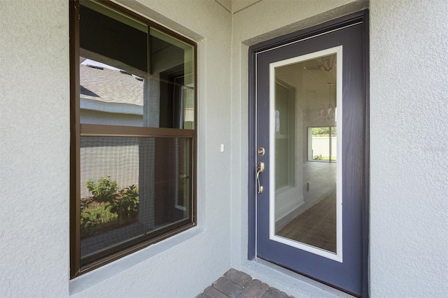 doorway to property with stucco siding