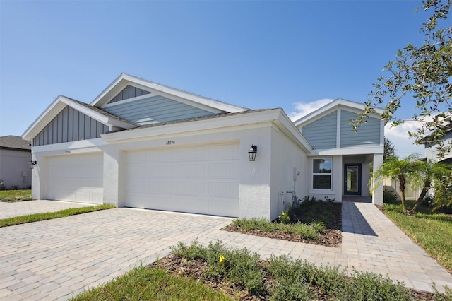 view of front of home with a garage, decorative driveway, and board and batten siding