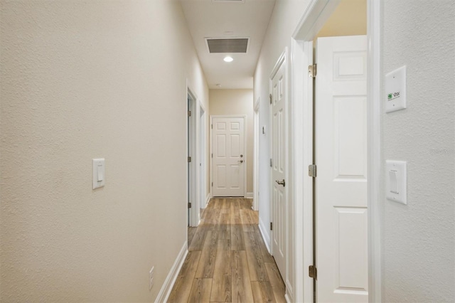 hallway with light wood-type flooring