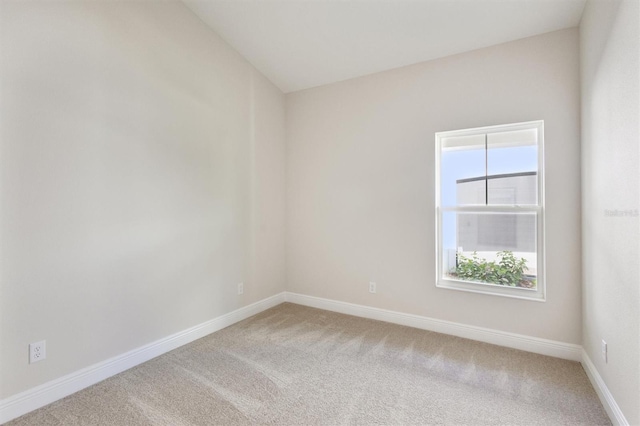 empty room with carpet and baseboards