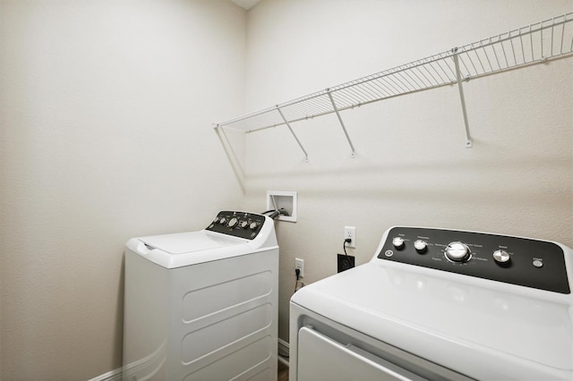 washroom featuring laundry area and separate washer and dryer