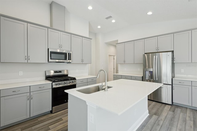 kitchen featuring a sink, stainless steel appliances, and light countertops