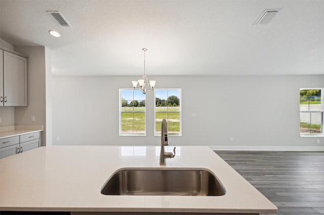 kitchen featuring visible vents, light countertops, and gray cabinetry