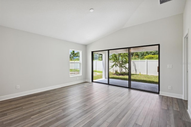 unfurnished room featuring hardwood / wood-style floors and vaulted ceiling