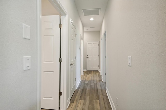 hallway with hardwood / wood-style flooring