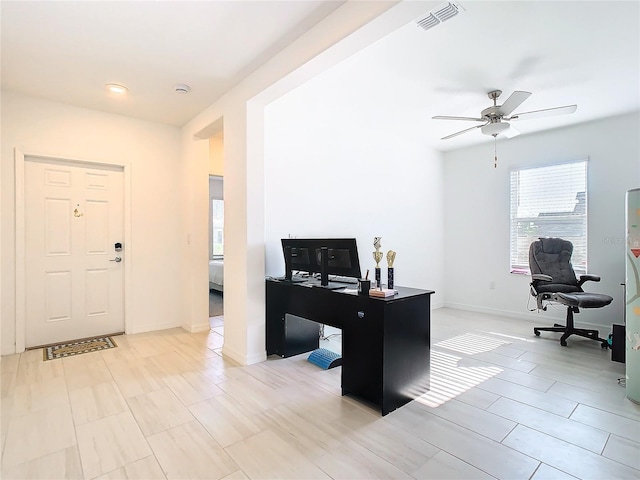 home office featuring a wealth of natural light and ceiling fan