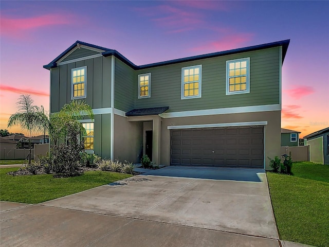 view of front facade with a yard and a garage