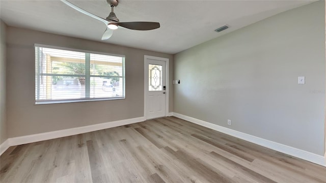 entryway with a ceiling fan, visible vents, baseboards, and wood finished floors