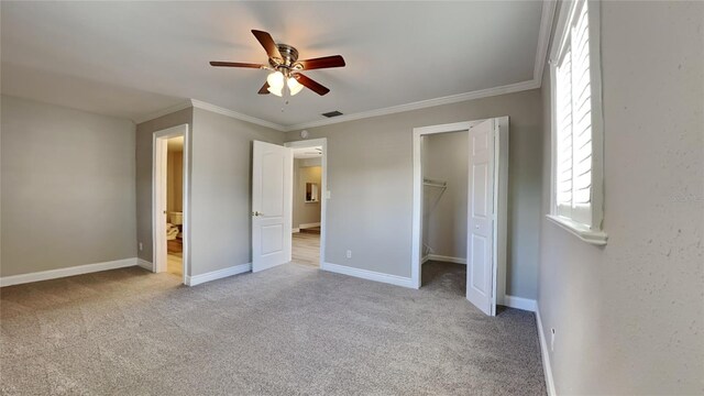 unfurnished bedroom with ceiling fan, carpet flooring, baseboards, ornamental molding, and a closet