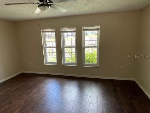 spare room with ceiling fan, dark hardwood / wood-style floors, and a textured ceiling