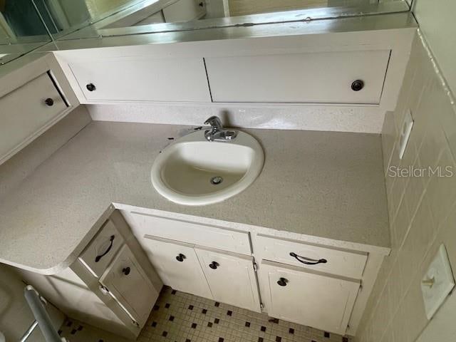 bathroom with tile patterned floors and vanity