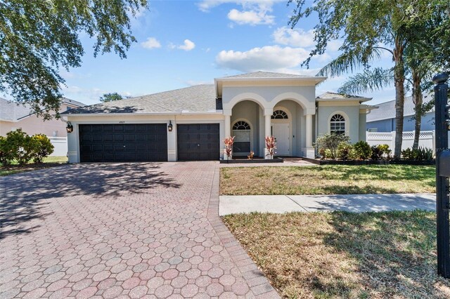 view of front facade with a garage and a front lawn