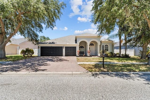 view of front of house with a garage and a front lawn