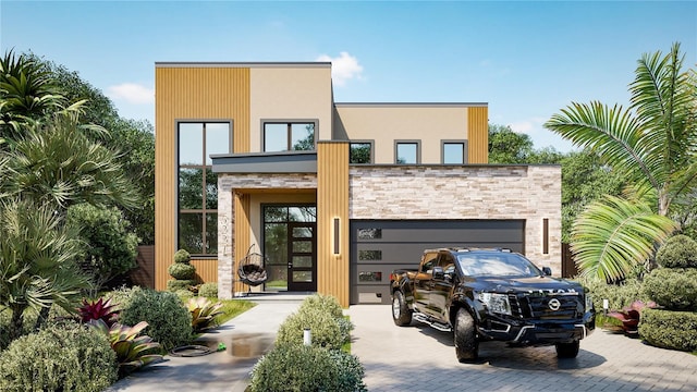 modern home with an attached garage, stone siding, and decorative driveway