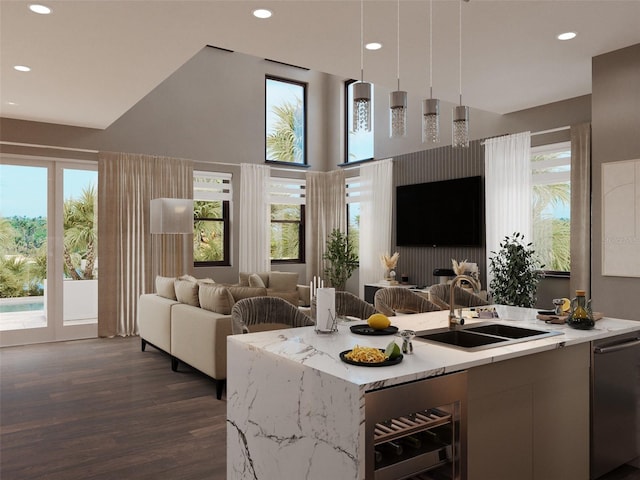 kitchen featuring wine cooler, a sink, open floor plan, hanging light fixtures, and plenty of natural light