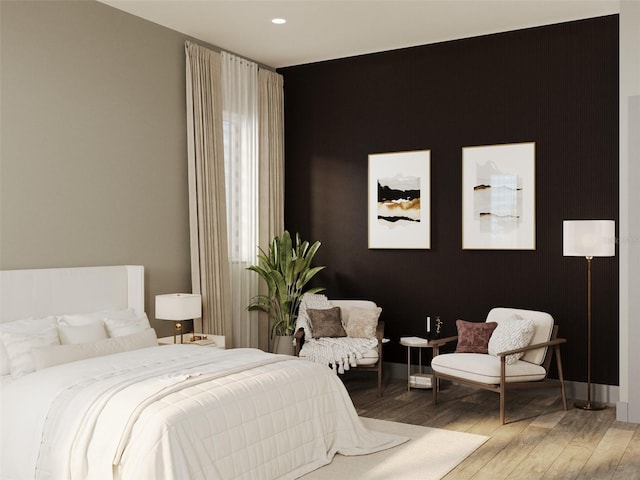 bedroom featuring wood finished floors and recessed lighting