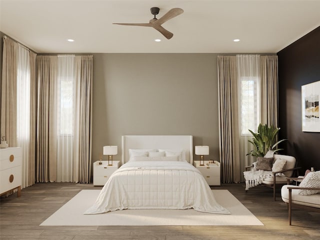 bedroom featuring a ceiling fan, wood finished floors, and recessed lighting