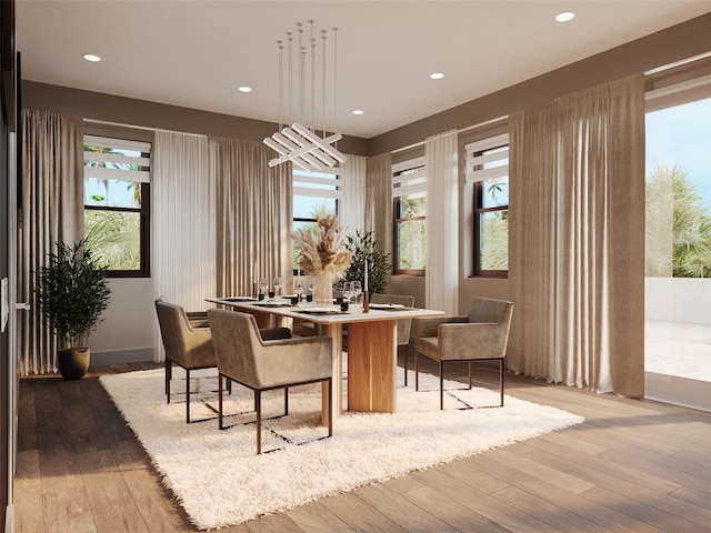 dining room featuring a healthy amount of sunlight and hardwood / wood-style flooring