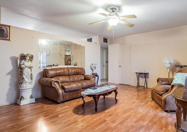 living room with ceiling fan and light wood-type flooring