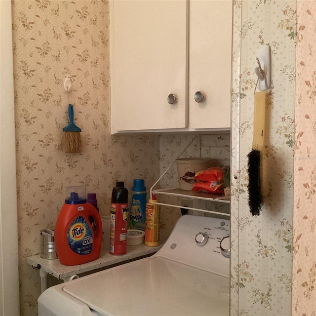 washroom featuring cabinets and washer / dryer