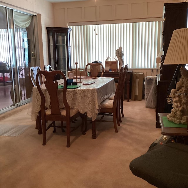 dining space featuring light colored carpet