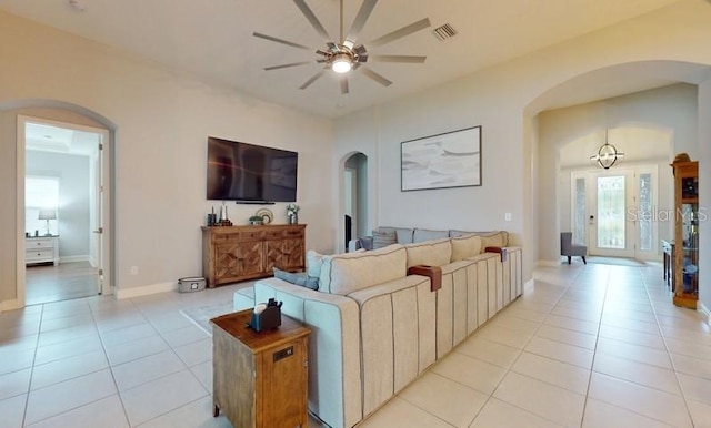 tiled living room with ceiling fan