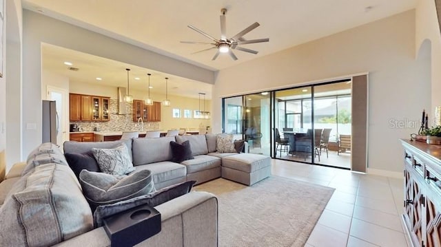 living room featuring ceiling fan and light tile patterned floors