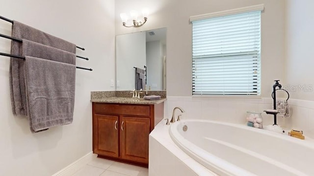 bathroom with vanity, tile patterned floors, and a relaxing tiled tub