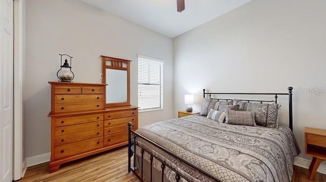 bedroom with ceiling fan and light hardwood / wood-style flooring