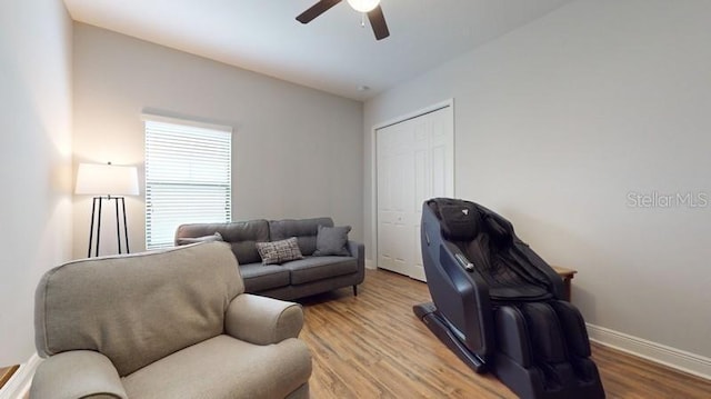 living room featuring hardwood / wood-style flooring and ceiling fan