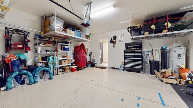 garage featuring water heater and a garage door opener