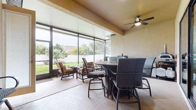 sunroom / solarium featuring ceiling fan and a wealth of natural light