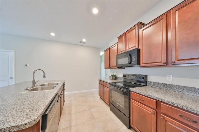 kitchen with a kitchen island with sink, sink, light tile patterned floors, and black appliances