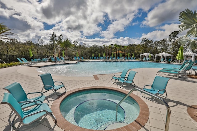 view of swimming pool featuring a gazebo, a community hot tub, and a patio