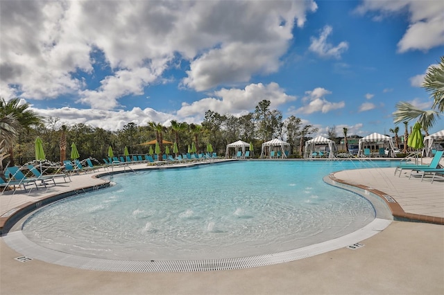 view of swimming pool featuring a gazebo, pool water feature, and a patio area