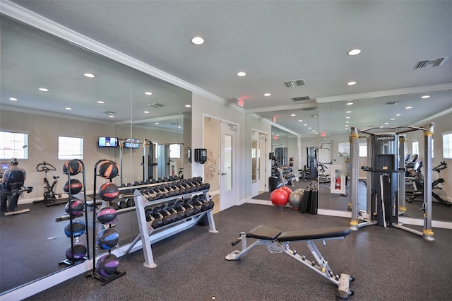 workout area featuring ornamental molding and a textured ceiling