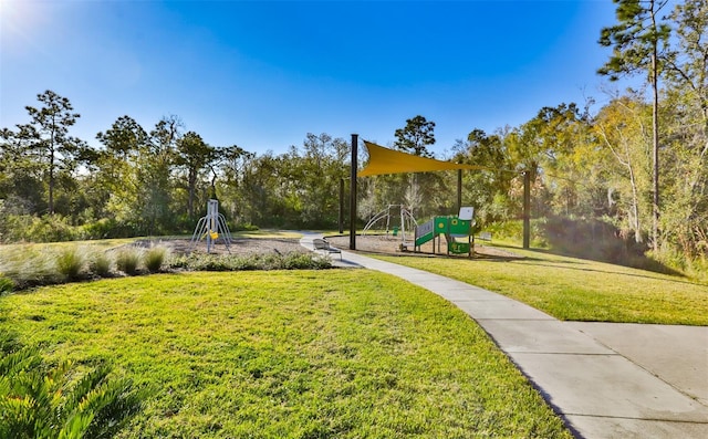 view of home's community with a playground and a lawn