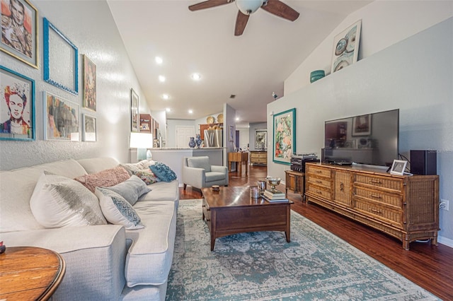 living room featuring dark hardwood / wood-style flooring, vaulted ceiling, and ceiling fan