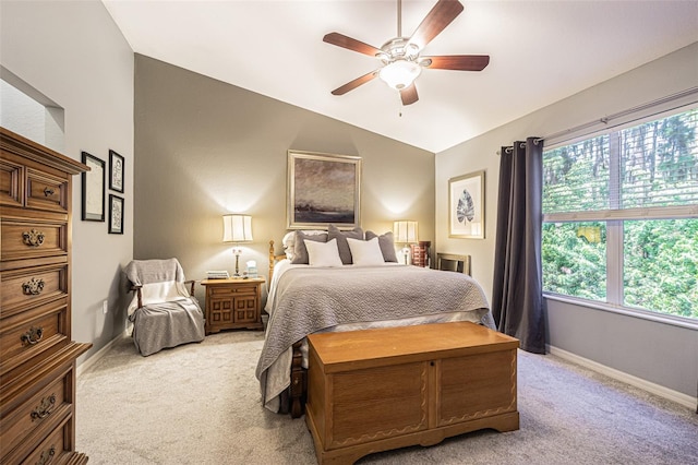 carpeted bedroom featuring multiple windows, ceiling fan, and lofted ceiling