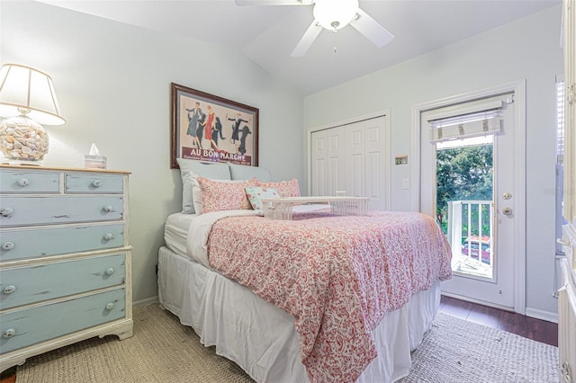 bedroom with access to exterior, ceiling fan, light hardwood / wood-style flooring, vaulted ceiling, and a closet