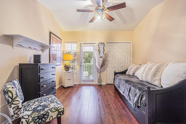 living area featuring dark hardwood / wood-style floors, ceiling fan, and lofted ceiling