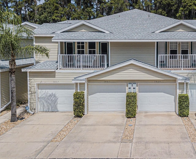 multi unit property with a balcony and a garage