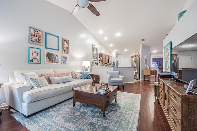 living room featuring ceiling fan, dark hardwood / wood-style floors, and vaulted ceiling