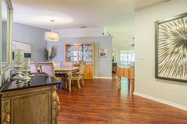 dining space with ceiling fan and dark wood-type flooring