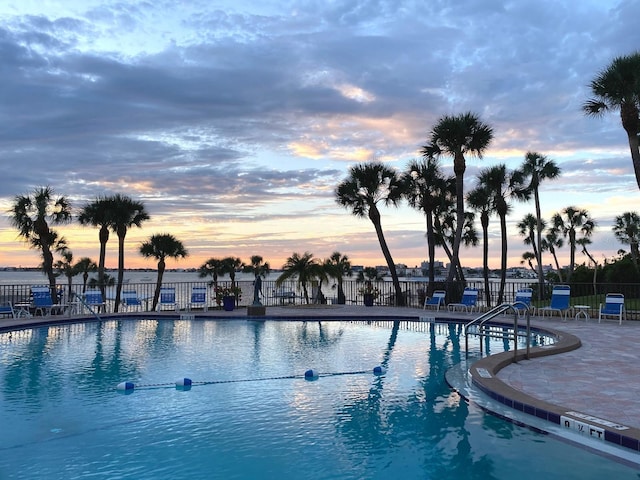 pool at dusk with a patio