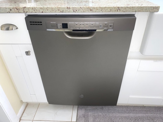 interior details with dishwasher and white cabinetry