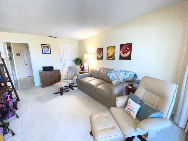 carpeted living room featuring a textured ceiling