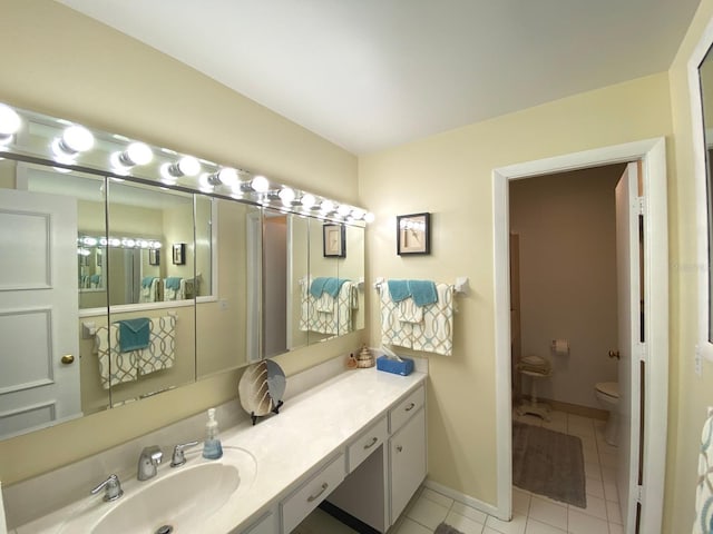 bathroom with tile patterned floors, vanity, and toilet