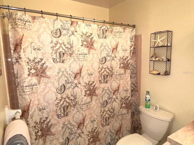 bathroom featuring walk in shower and toilet