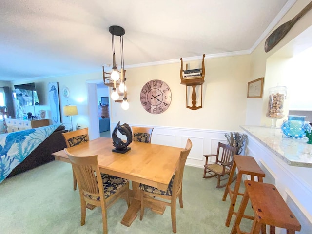 carpeted dining space featuring ornamental molding